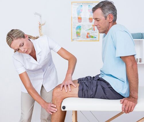 The doctor performs a visual examination and palpation of a patient with knee pain
